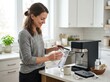 © Aliaksandr Barouski - Woman cleaning coffee machine in modern kitchen morning home routine