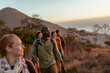 © Marko Geber - Friends hiking on a mountain trail at sunset
