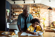 © Davor - Grandfather helping child with homework at kitchen table