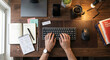 © R freelance  - Person typing on keyboard with coffee and notebook on wooden desk