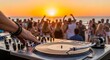 © mahrtgfx - Close Up Of DJ Hands Mixing On Turntable At Vibrant Summer Beach Party Sunset Event