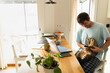 © Alba Vitta Studio/Stocksy - Man Sits at Desk With Cat in a Home Office in the Morning
