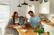 © Alba Vitta Studio/Stocksy - Couple Works Together in Kitchen With Cat