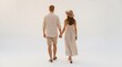 © Rima - Couple in casual summer attire holding hands and walking on a bright beach.