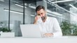 © Bonsales - Distraught man seated at a desk wiping tears with a tissue, overwhelmed by feelings of stress, sorrow, emotional turmoil, and loss in a workplace setting