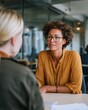 © TAlex - HR manager consulting employee in modern office meeting room