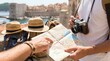 © MT - Two young adult tourists planning European coastal city sightseeing route with paper map and vintage camera, travel adventure concept