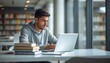 © Trendy stock for you - Young student man using laptop for study in university library near window with university studying education learning technology research computer academic knowledge internet daylight