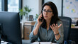 © Thodsapol - Concerned businesswoman talking on the phone at her office desk while reviewing work issues, handling customer inquiries and solving problems.
