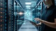 © Leo - Female IT specialist in server room using tablet to manage cloud computing and data center networks, holographic interface showing analytics and security systems