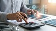 © Abdullah - Doctor or medical professional calculating healthcare costs on calculator with tablet showing rising financial graphs and heart health statistics for hospital budget management