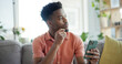 © peopleimages.com - Thinking, cellphone and black man on sofa in home with networking, connection or texting on mobile app. Relax, decision and African person with phone for chatting, communication or social media.