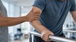 © Alexey - Physiotherapist supporting man during arm rehabilitation exercise. Specialist helping patient recover mobility using parallel bars in clinic. Medical recovery and physical therapy training.