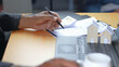 © Siwaporn - Business professional analyzing real estate and mortgage documents at office desk with calculator, laptop and house models. Concept of home loan approval, property investment, financial planning
