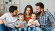 © fuad - Happy parents with two fathers and a mother laughing with their young children at home Wallpaper Background image