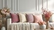© Gus - Interior scene showcases a comfortable sofa adorned with textured throw pillows and dried floral arrangements against a paneled wall.