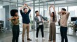 © Eve - Diverse multiethnic office team doing stretching exercises during work break. Healthy happy multicultural colleagues practicing corporate wellness and active lifestyle in modern workspace.