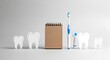 © Mom Studio - Dental hygiene tools arrangement on minimalist gray surface with copy space
