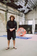 © Luciano Spinelli/Stocksy - Man Stands confident in Industrial Space