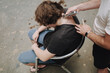 © Luciano Spinelli/Stocksy - Shave clients neck after haircut