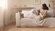 © WS Studio 1985 - Relaxed woman sitting on sofa reading book in cozy living room