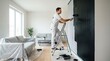 © Photopia - Black accent wall painting, Contemporary living room renovation, Bold interior color update, Professional painter at work, Clean modern home decor