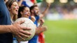© SimpleDesignStudio - Group of Excited Young Adult Soccer Fans Cheering at Stadium Match Holding Ball Concept of Sports Fandom and Team Spirit