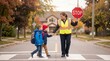 © velikiyzayats - Crossing guard helping two young elementary school children cross the street safely on a suburban road during autumn, representing community safety and education