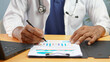 © Siwaporn - Healthcare professional analyzing medical data and patient reports with charts and graphs. Medical research, healthcare analytics, hospital management, clinical assessment, and data-driven decisions.