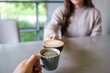 © Farknot Architect - Closeup image of couple people clinking coffee cups in cafe