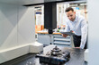 © Westend61 - Businessman using tablet at a machine in a modern factory