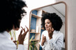 © Westend61 - Young woman applying lip care