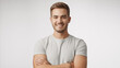 © SHUMAYA - Smiling young man with arms crossed