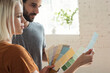 © Westend61 - Young couple in a loft looking at color samples