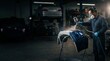 © A.Ishchenko - Professional automotive technician spray painting car bumper in auto repair shop