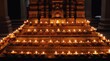 © Pete - Rows of lit diyas in a temple create a warm, golden glow. The terracotta lamps are arranged on tiered stpic before an ornate altar, symbolizing spiritual devotion and celebration.