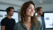 © Phirakhup - Woman business professional office smile teamwork collaboration portrait woman smiling in modern office with blurred coworker and screen