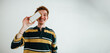 © Julia - Young man portrait with smartphone in studio for mobile technology and social media concept