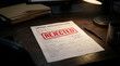 © Rasel - Job application form marked with rejected stamp on dimly lit executive office