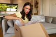 © Home-stock - Confused lady customer unpacking delivered cardboard parcel with order, inspecting empty box after removing protective packaging