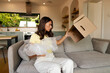 © Home-stock - Confused woman checking empty delivery box after unpacking, holding protective packaging in her hands, being concerned about missing product