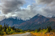 © jia - Mountain road winding through wilderness toward distant peaks