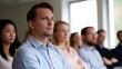© Bussakon - A group of professionals stands in a bright modern office environment suggesting a collaborative and focused work atmosphere
