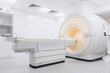 © wedmoments.stock - MRI scanner placed in a spacious modern radiology room with bright sterile white interior and clinical equipment. Concept medical diagnostics, imaging precision and healthcare environment.