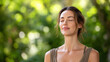 © Alexander - Peaceful mindful woman practicing outdoor meditation in green forest garden, closed eyes and gentle smile, natural wellness lifestyle, emotional balance, relaxation, stress relief,