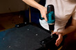 © Евгений Вершинин - Person using cordless drill to assemble upholstered furniture