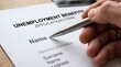 © Seon - Hand Filling Out Unemployment Benefits Application Form