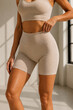 © Hanskie28 - Athletic Woman Modeling Modern Neutral Tone Fitness Apparel in Natural Studio Light