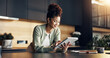 © peopleimages.com - Finance, woman and happy with tablet in home for insurance payout, loyalty reward and review. Budgeting, african person and smile with digital wallet for positive credit score, tax refund and wealth
