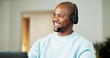 © peopleimages.com - Consultant, home and black man with headset for online communication, remote work or helpful advice. Friendly, male person or freelance agent with smile, mic or laptop for virtual assistance in house